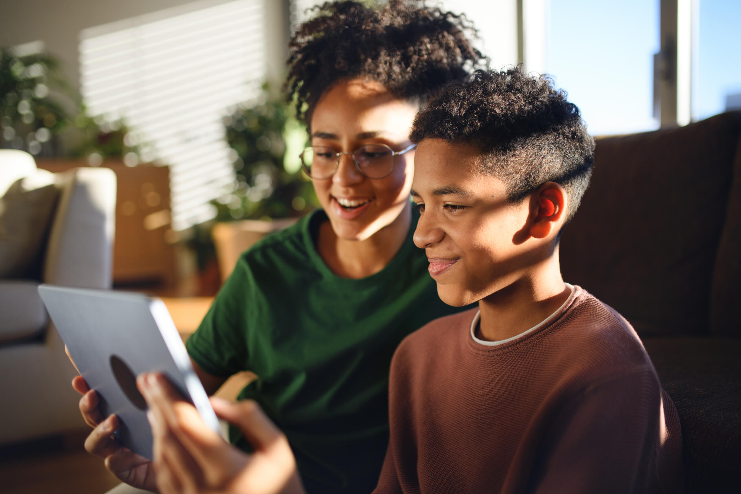 Young adults read a tablet