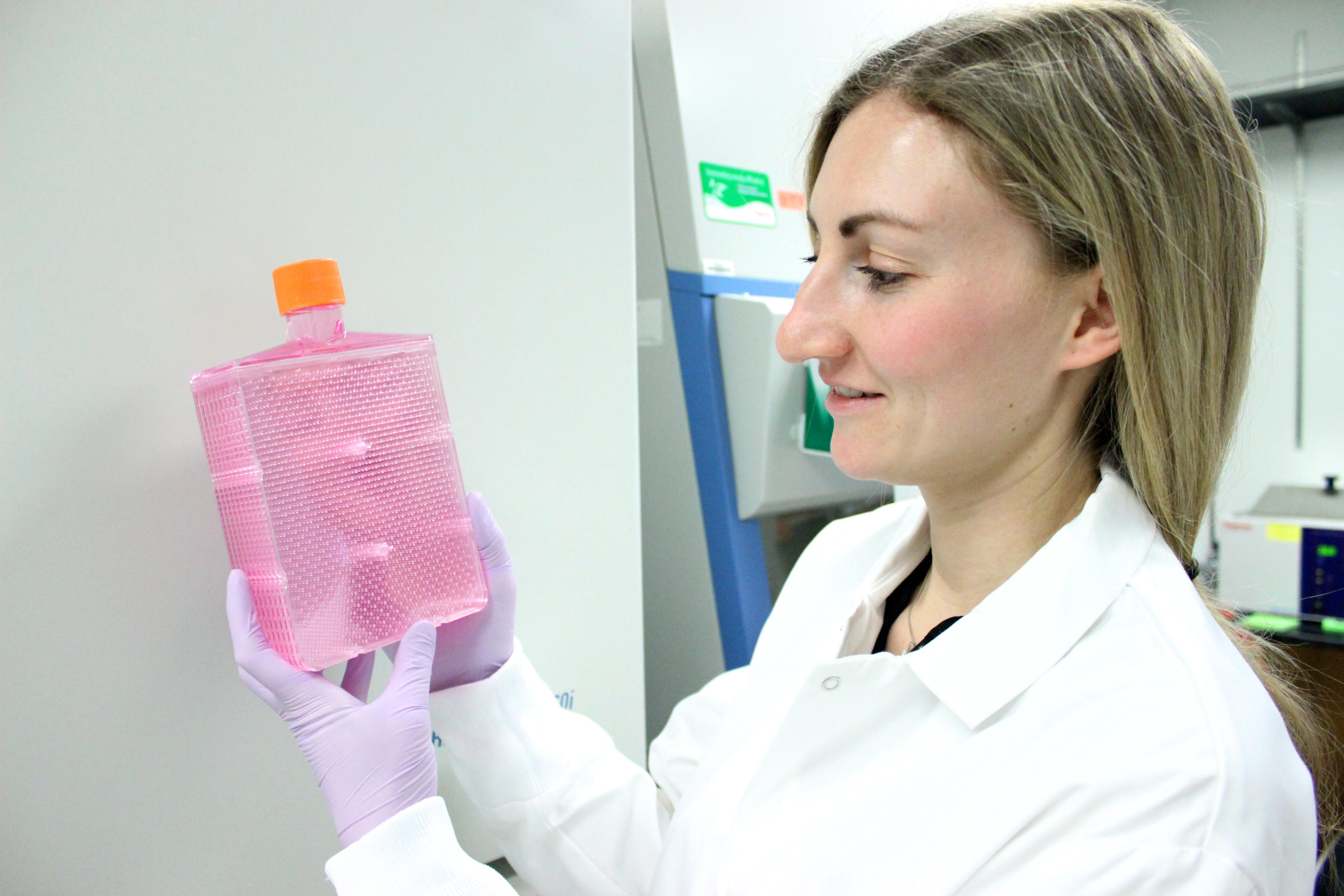 A girl holding a flask in the Millman laboratory