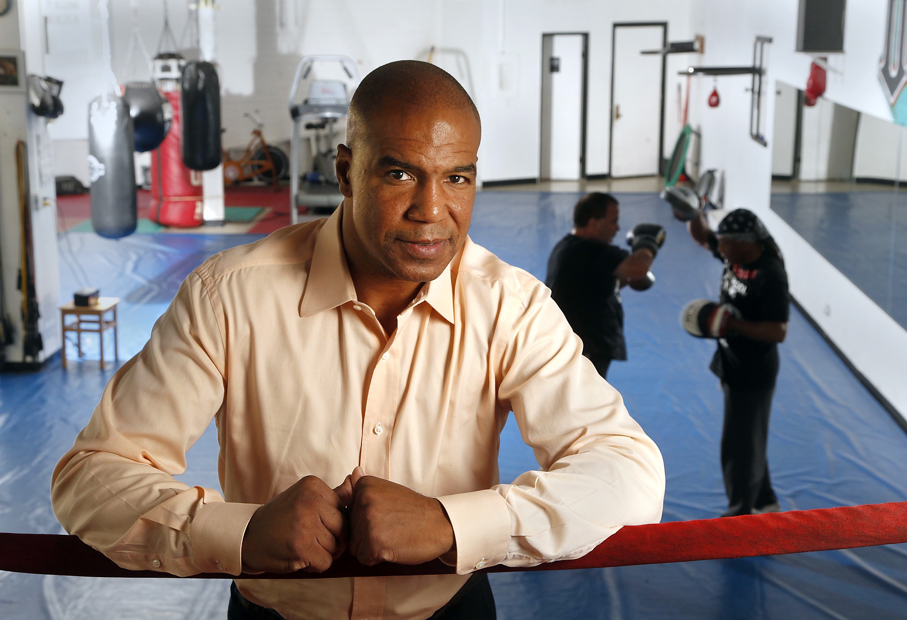 Paul Vaden stands in front of a boxing ring.