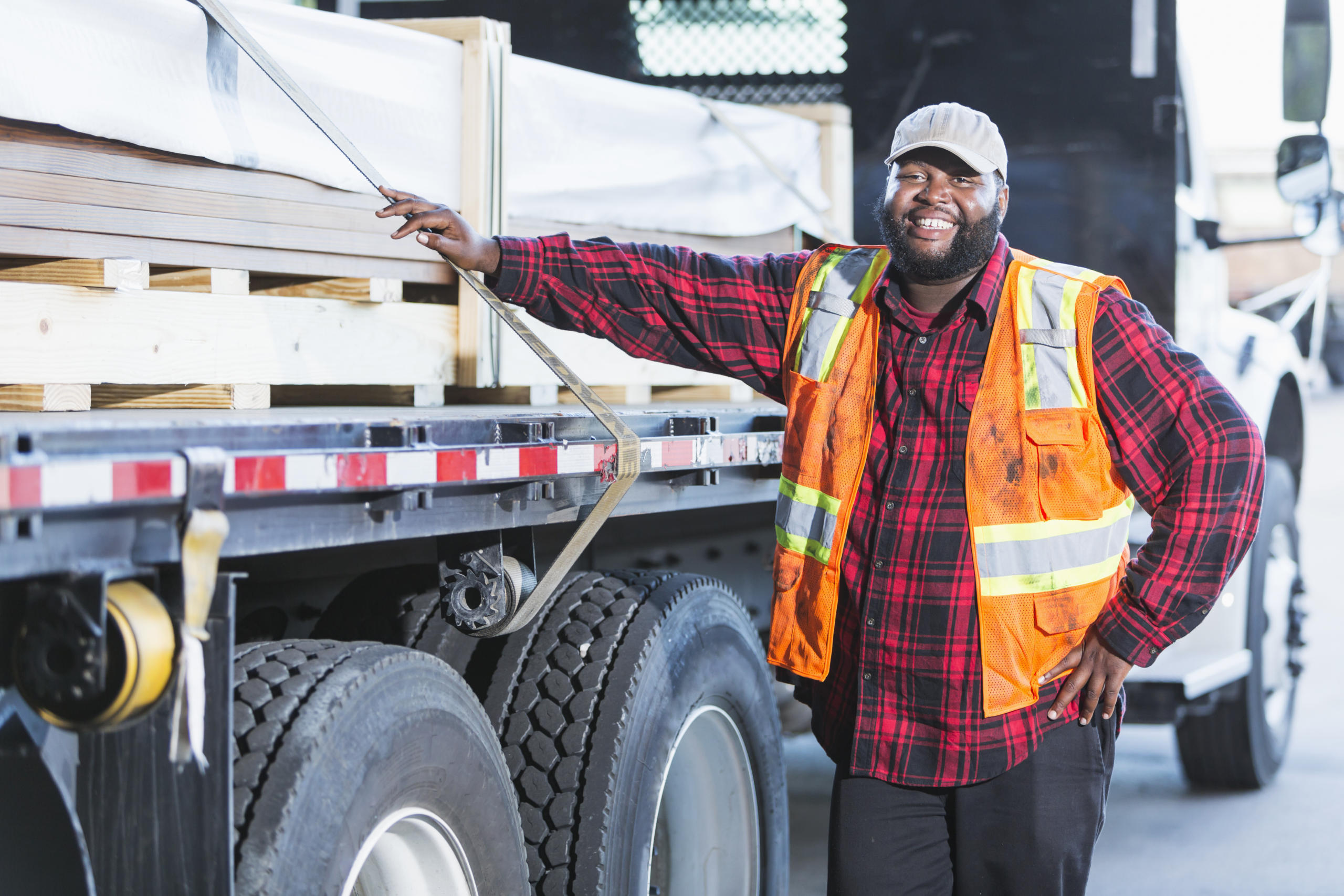 Worker standing by a truck