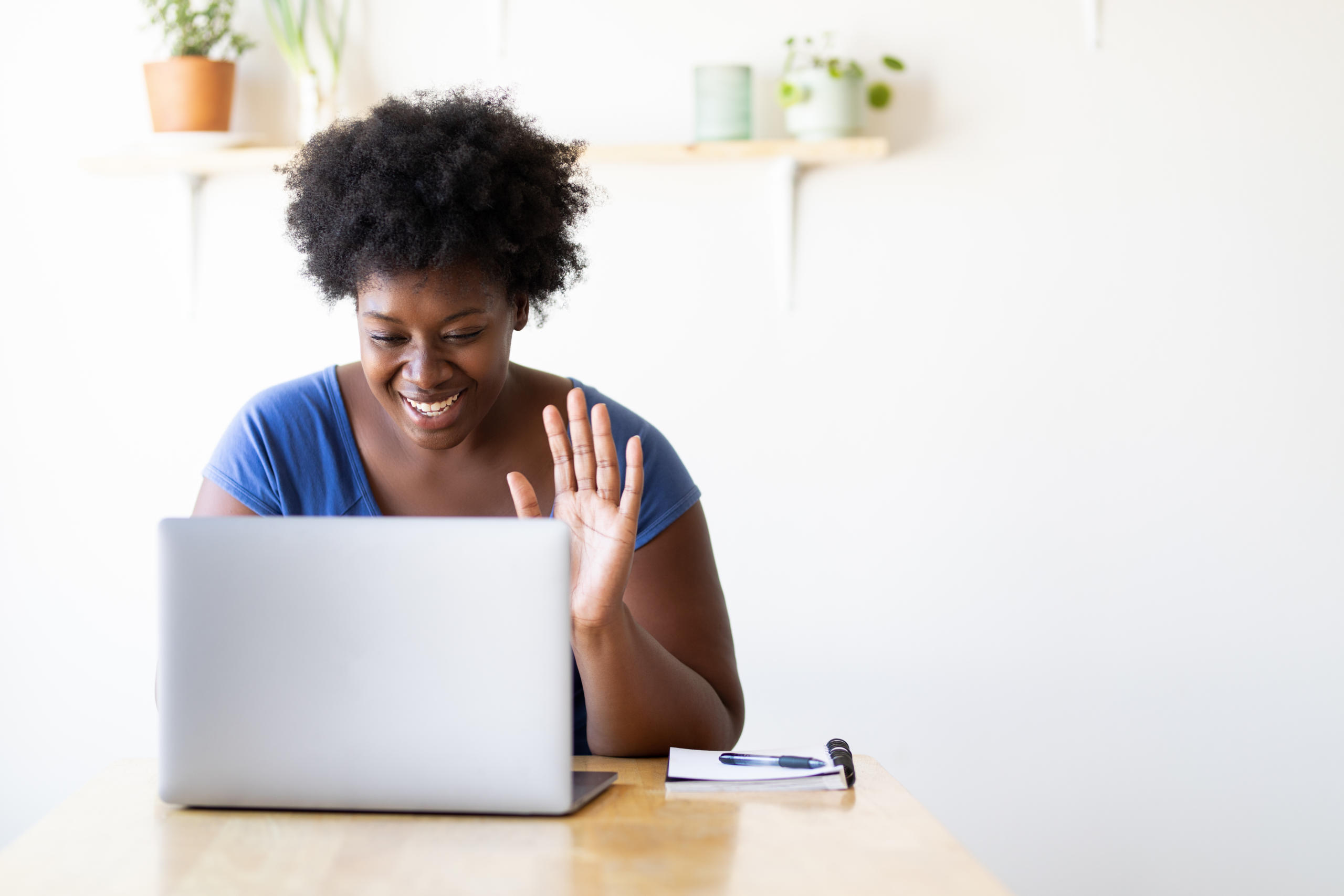 Woman at home having a virtual video call on her laptop.