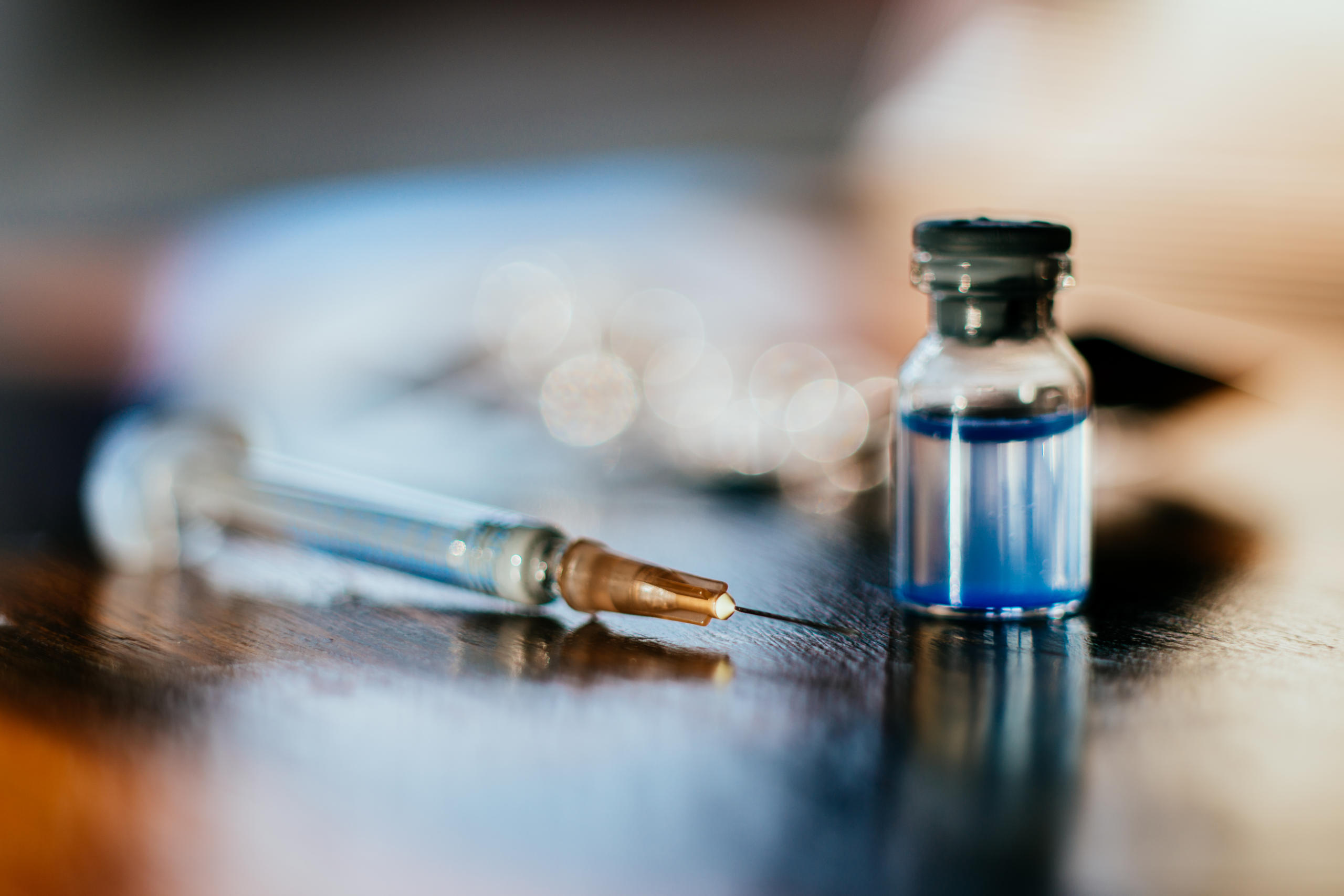 Insulin syringe and a vial on a table