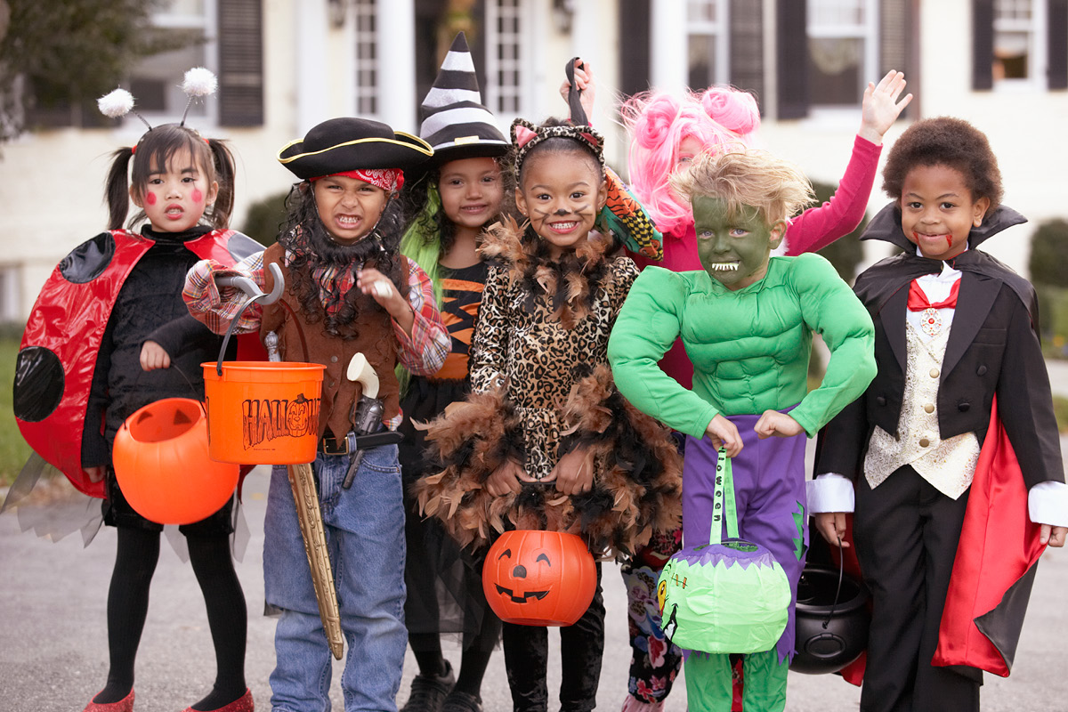 Group of children dressed in costumes for Halloween trick-or-treating