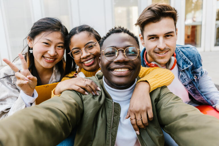 Portrait group of diverse student friends after class at university campus - Community, unity, teamwork and education concept