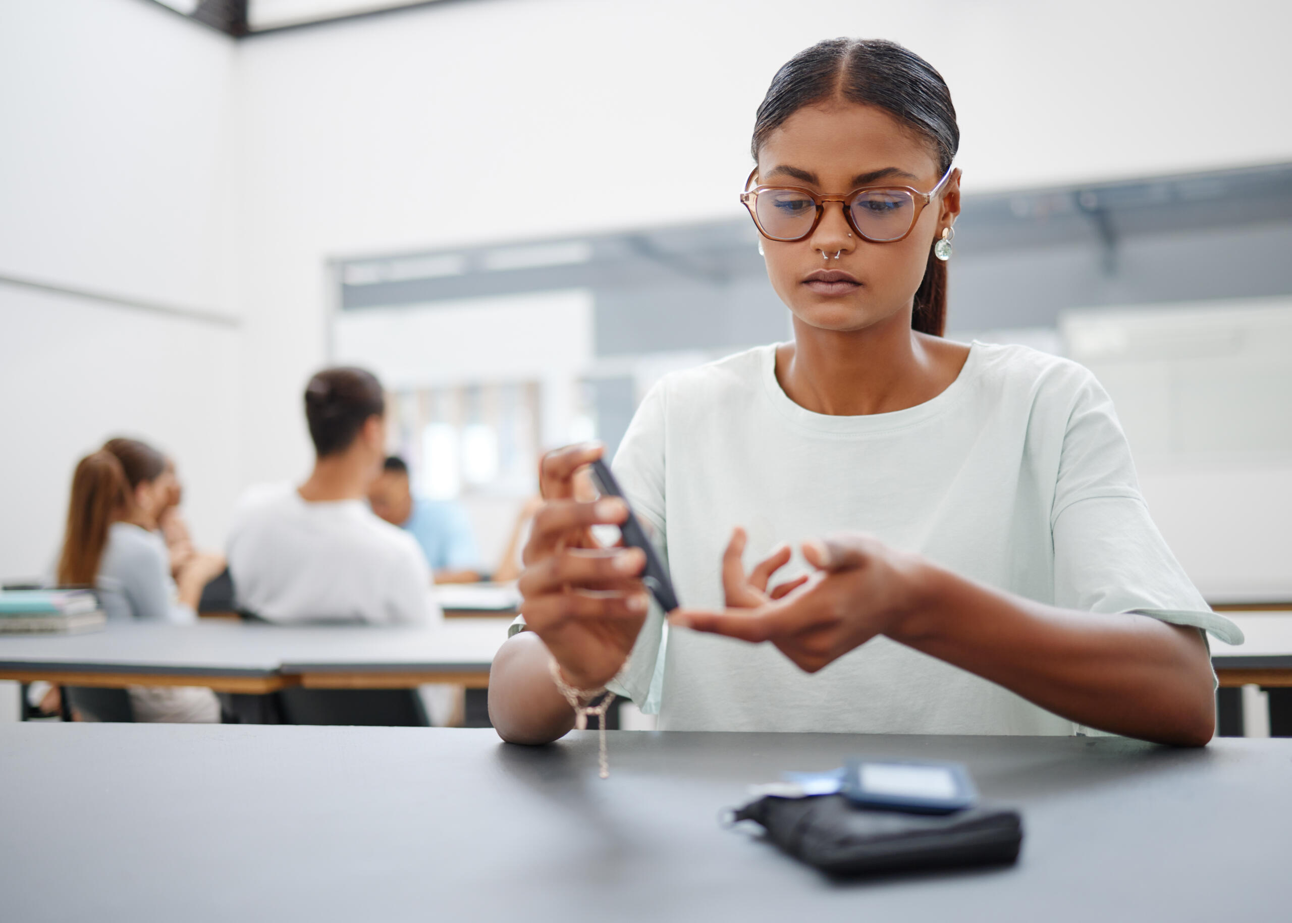 Young woman with type 1 diabetes checks her blood sugar