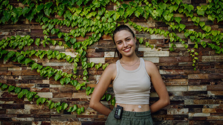 Young woman with type 1 diabetes wearing an insulin pump