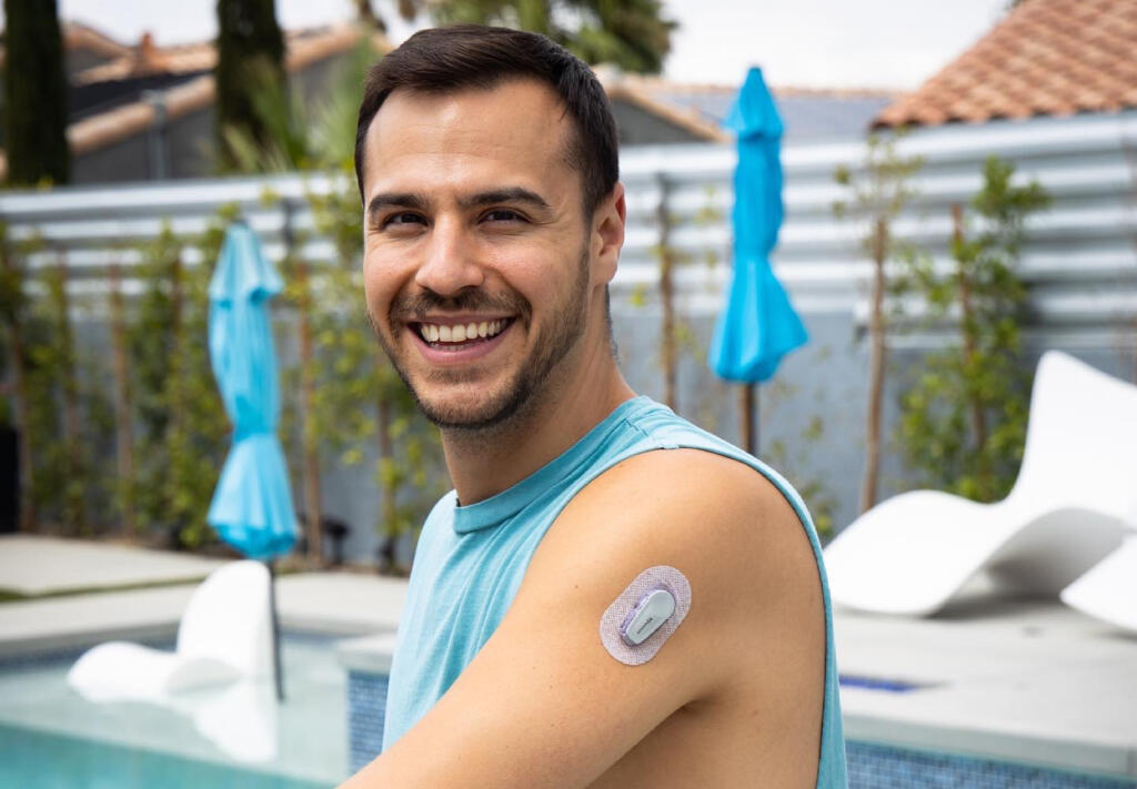 Young man with type 1 diabetes wears a Dexcom continuous glucose monitor (CGM)