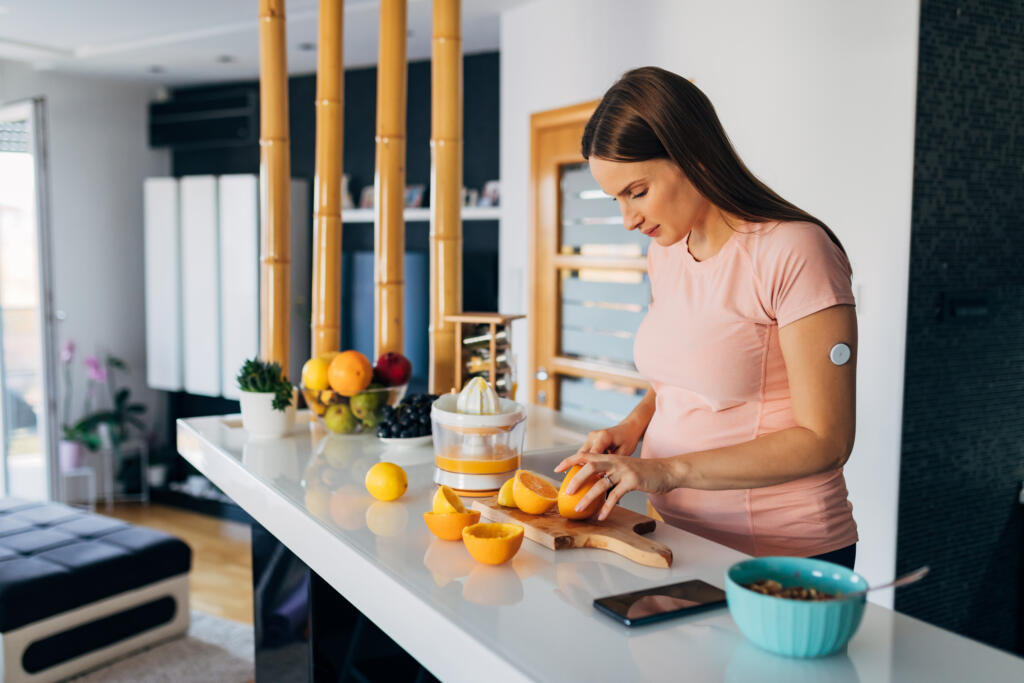 Pregnant woman with type 1 diabetes prepares a meal