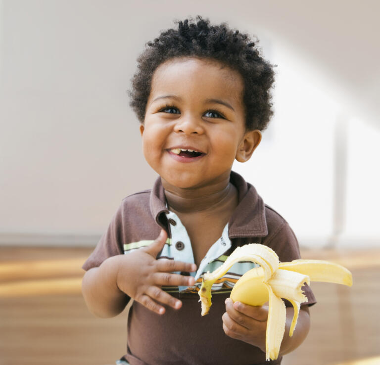 Toddler eating banana