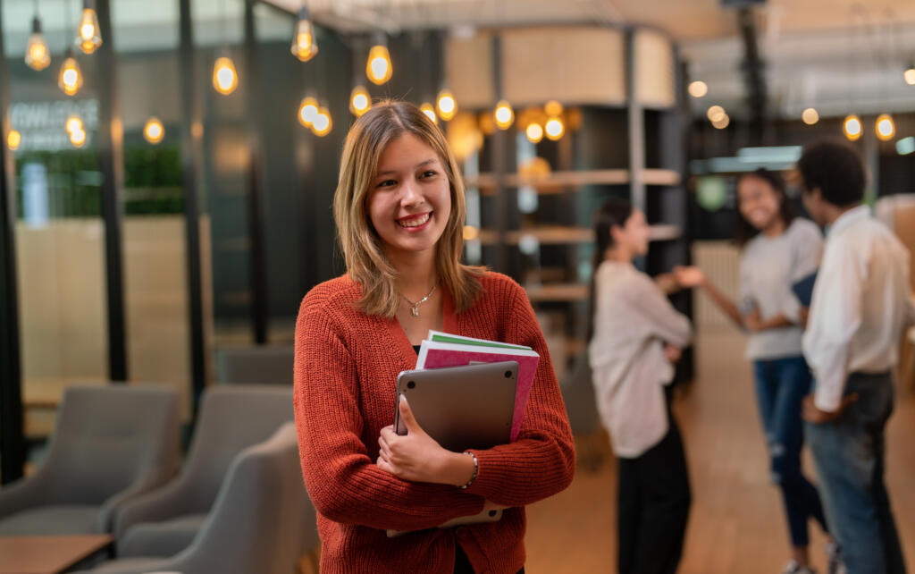 Young woman a studying at college.